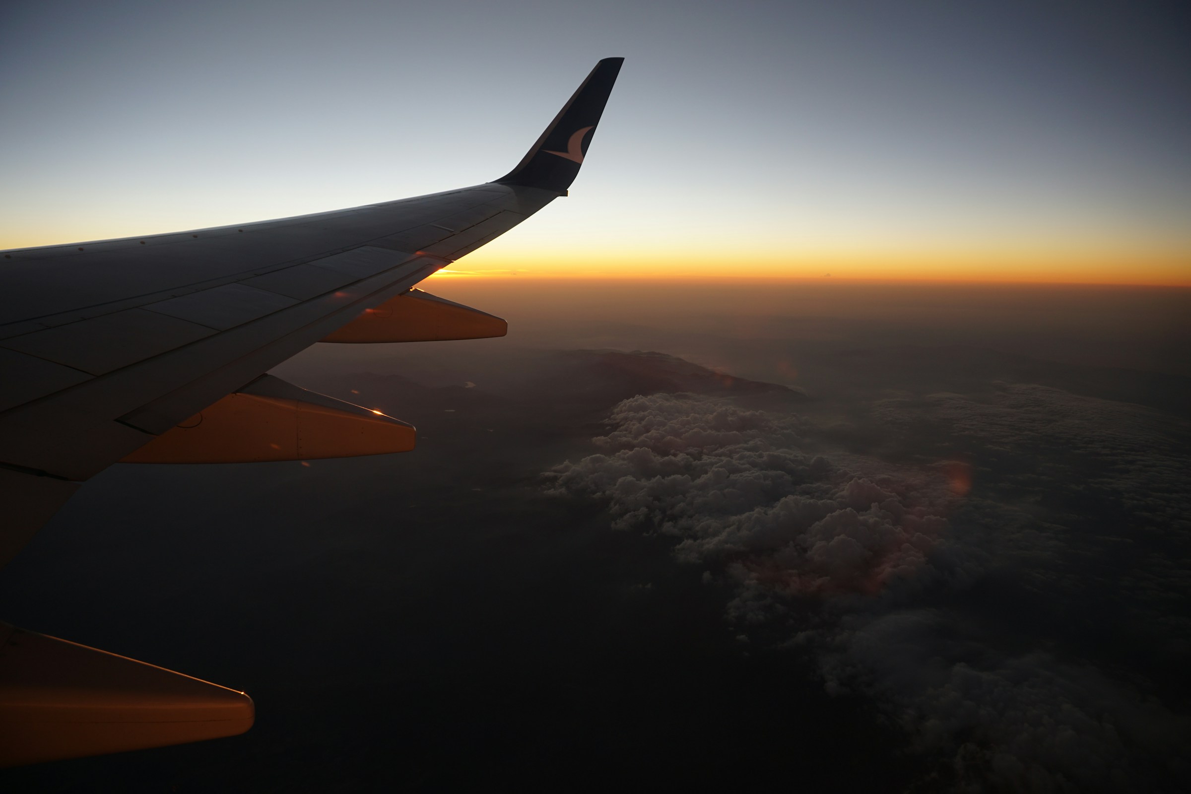 Airplane wing above clouds